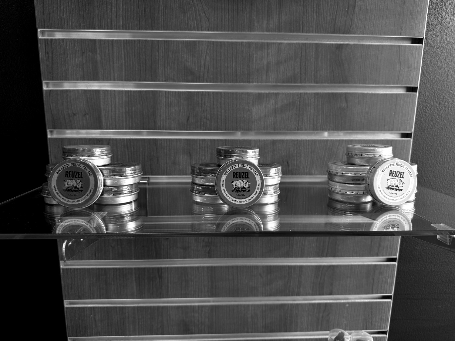 Reuzel pomade on the retail wall